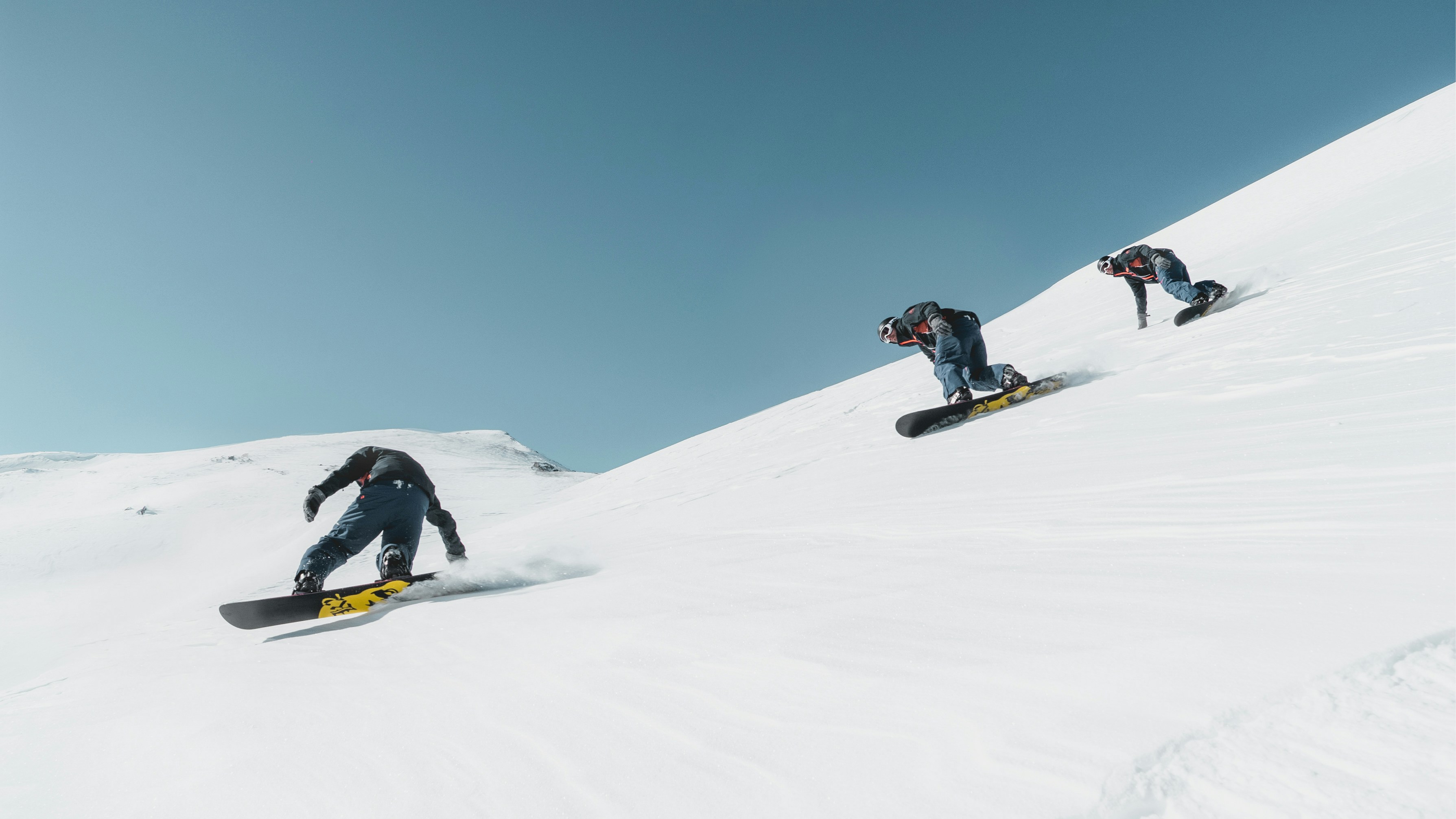 Friends gathering at a snowy overlook with branded heaters