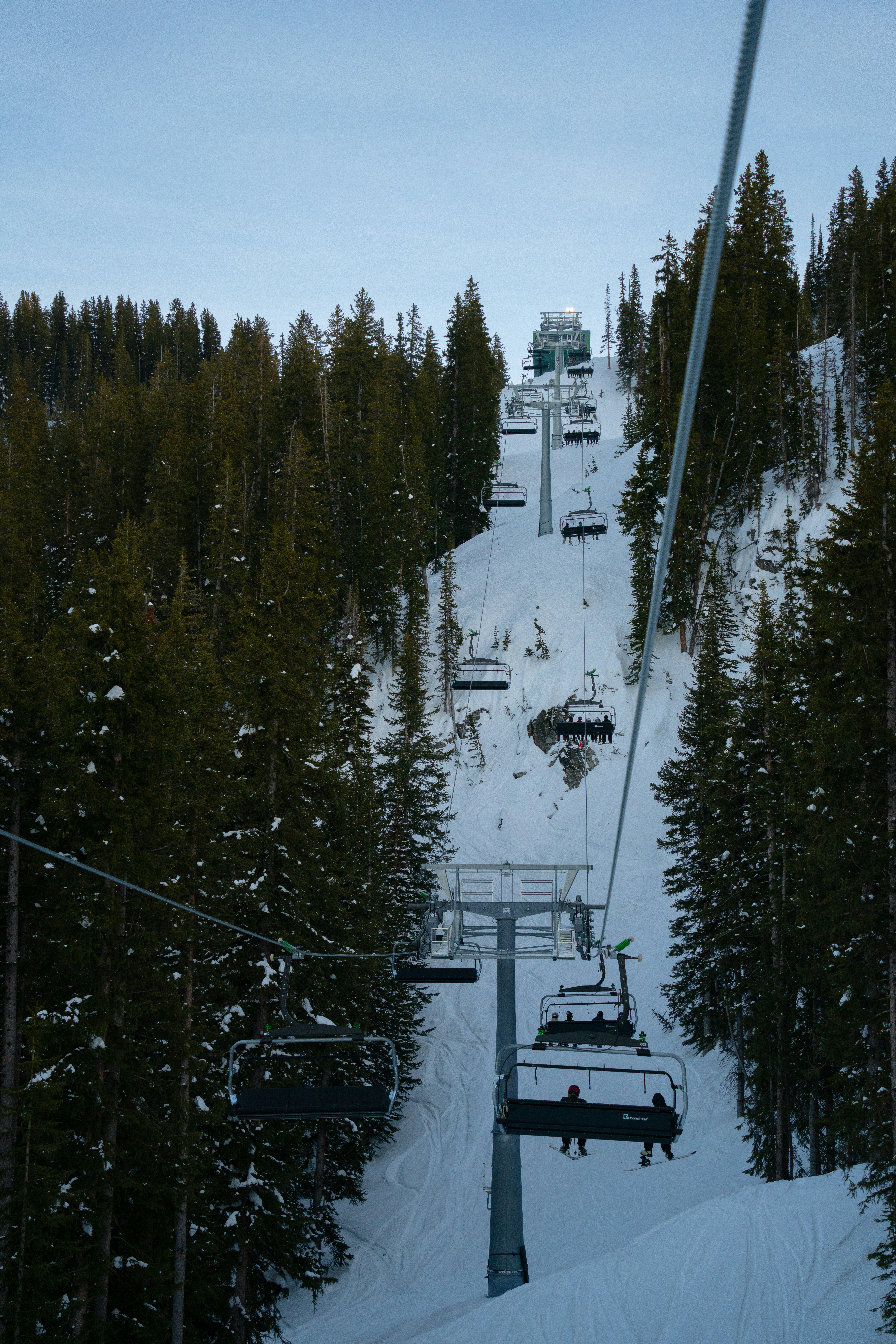 Ski lift carrying guests above a scenic mountain resort